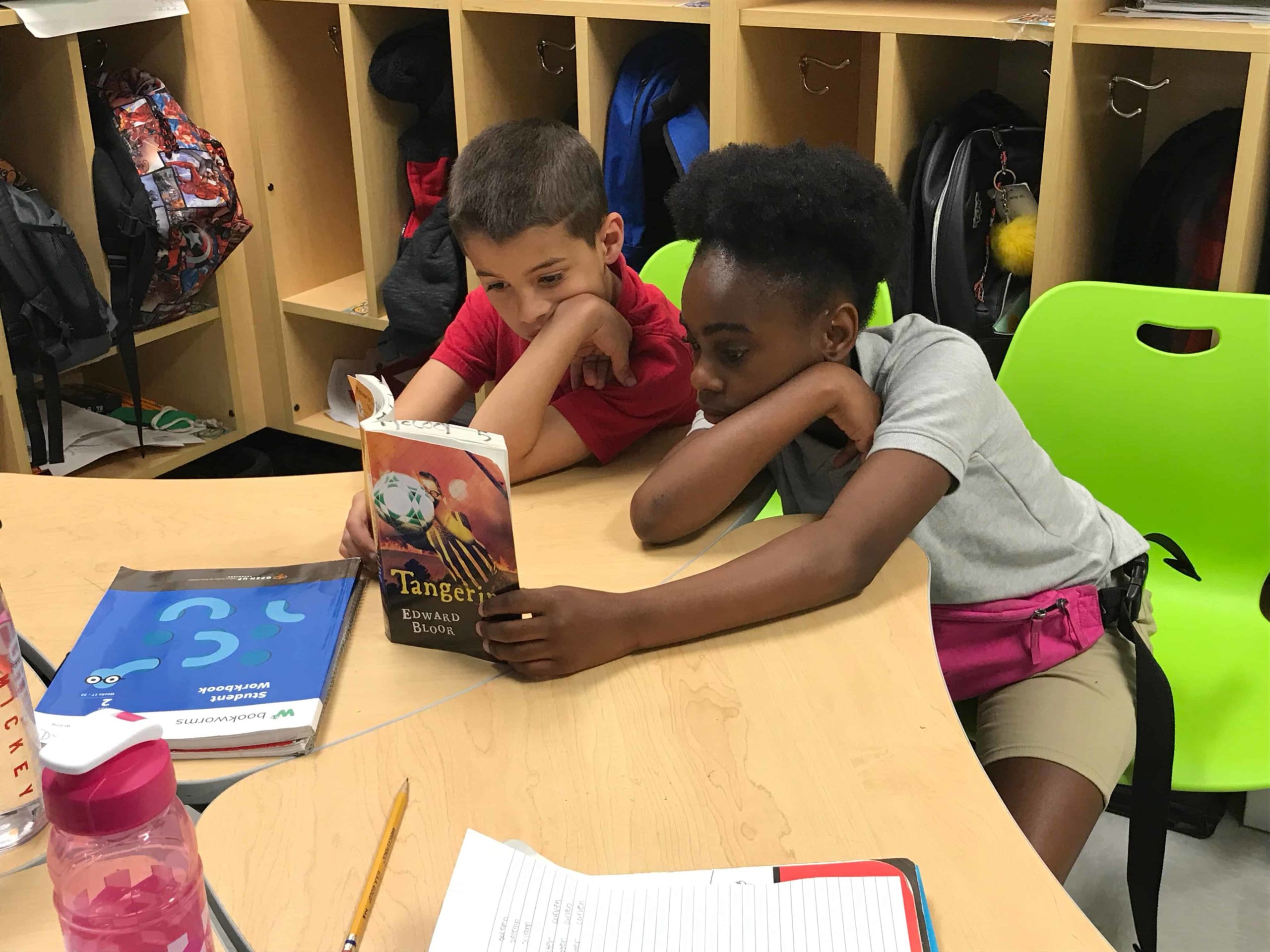 Students read a book together